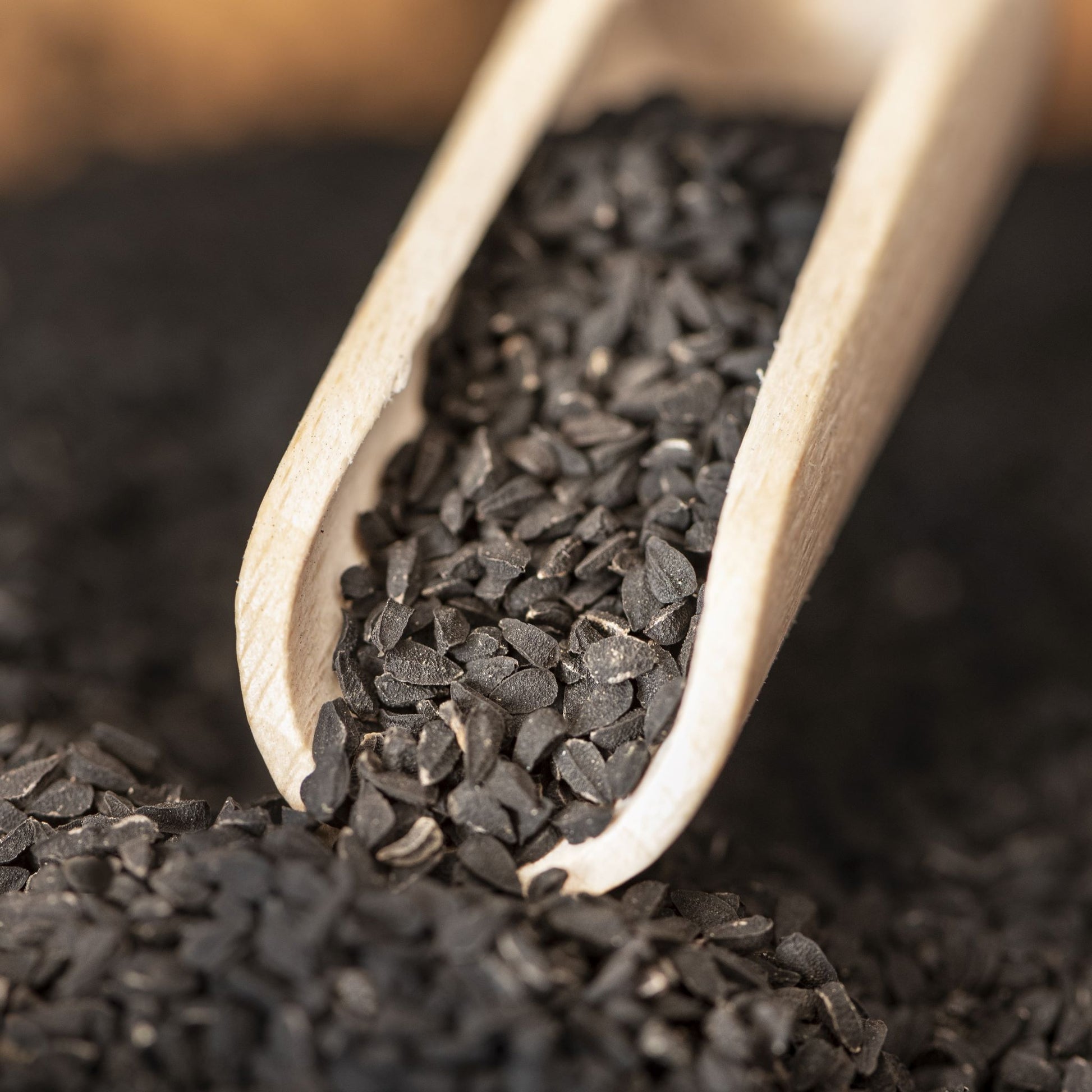 Close up of Black Cumin Seeds and wooden scoop